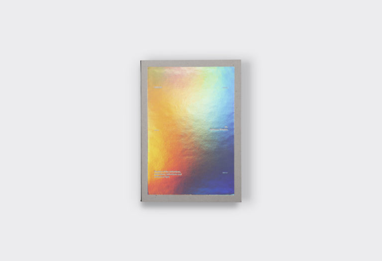 Isaac Newton's Opticks with holographic cover that reflects light into colors